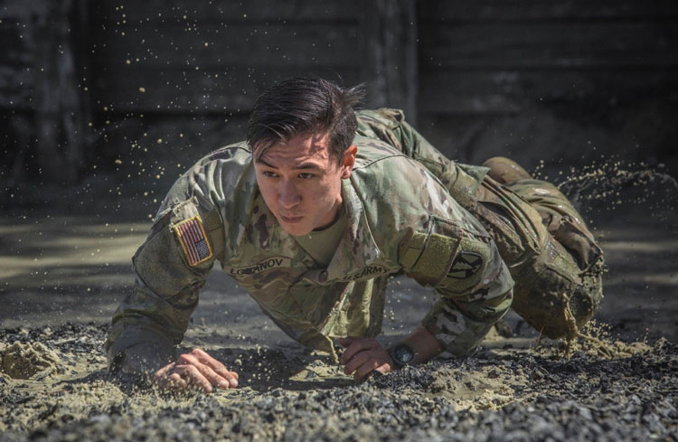 A cadre member with 1st Battalion, 61st Infantry Regiment demonstrates how to go through an obstacle at the Fort Jackson, S.C., Fit to Win 2 course, April 28, 2020. (U.S. Army photo by Tori Evans)