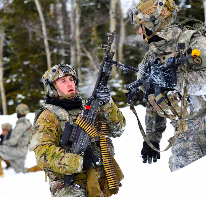 Soldiers in a snowy field with weapons.