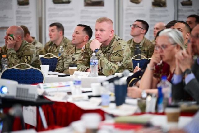 Soldiers sit listening at conference