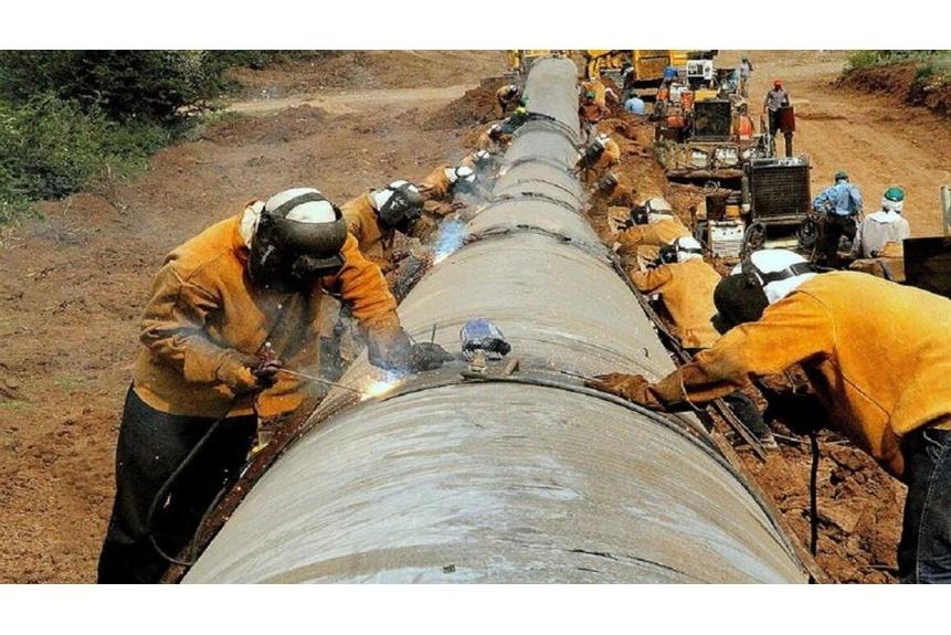 Workers construct a pipeline in Iran near Azerbaijan
